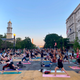 With the White House and Washington Monument off in the distance, D.C. protestors deal with their on-going PTSD by getting stretching out their mats along Black Lives Matter Plaza and doing some stress-relieving yoga poses.